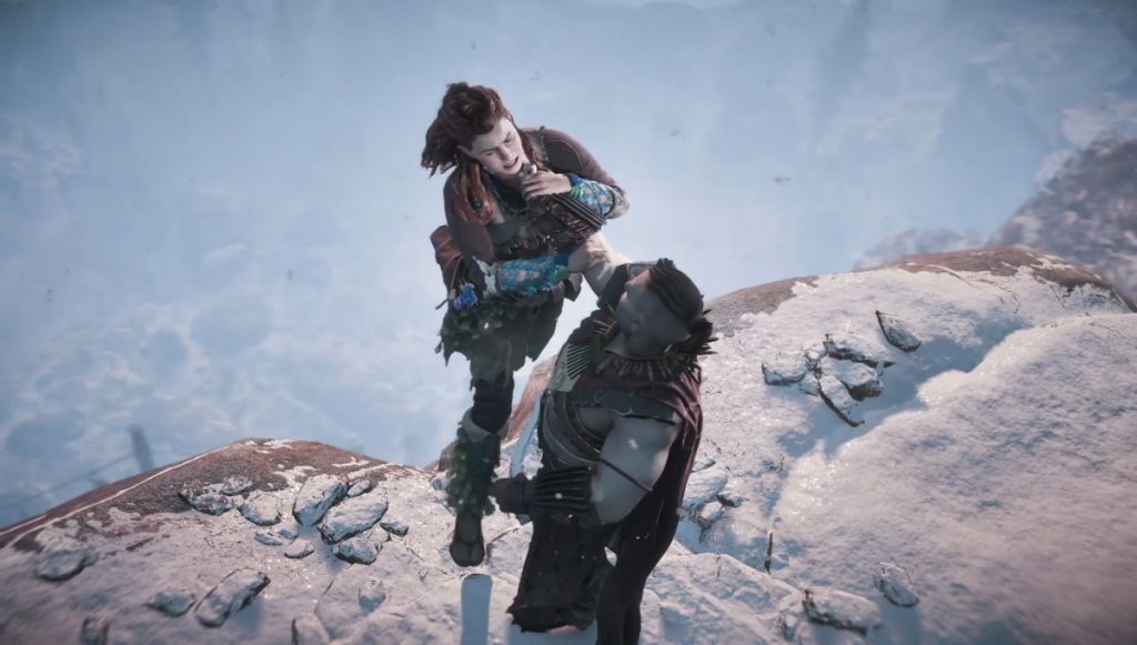 Aloy being held over the edge of a cliff